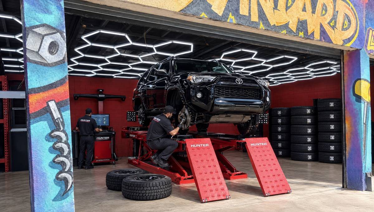 Toyota 4Runner on a Hunter wheel alignment rack with the wheels off in an LA Standard bay in Sun Valley